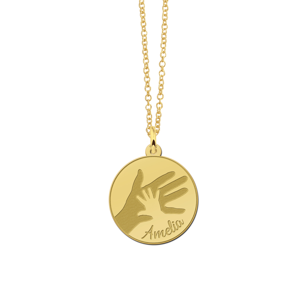 Goldener runder Anhänger mit großem und kleinem Handabdruck